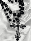 Gothic cross necklaceBlack beaded pendant necklaceVintage cross jewelryStatement cross pendantDouble strand black necklaceGothic fashion accessoriesFiligree cross pendant necklaceElegant black cross necklaceVictorian-inspired jewelryBlack beaded gothic necklace